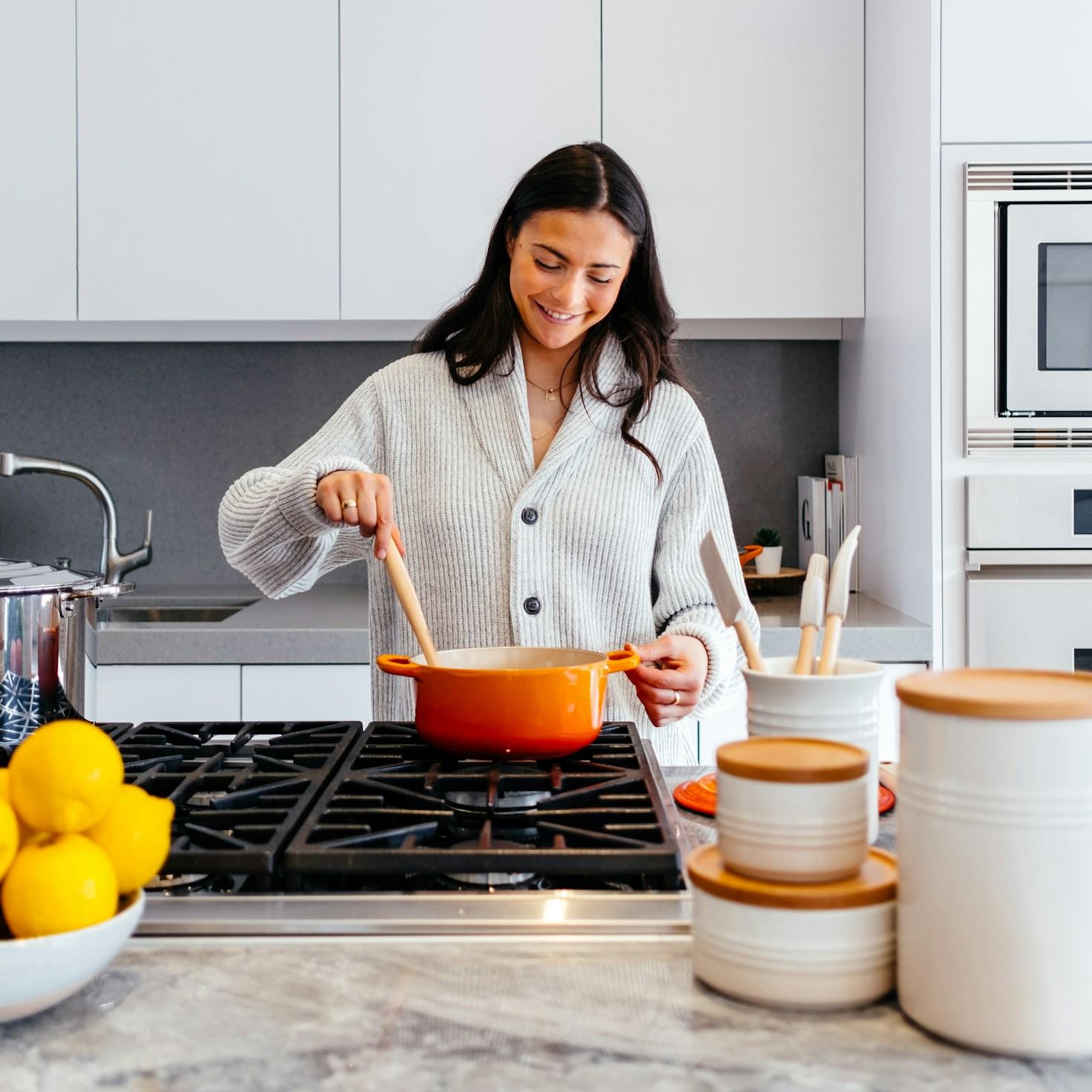 Community members collaborating in a modern kitchen space, sharing recipes and cooking techniques
